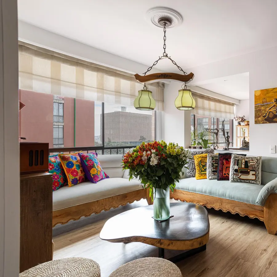 Bright living room with wood floors, warm walls and a pendant light