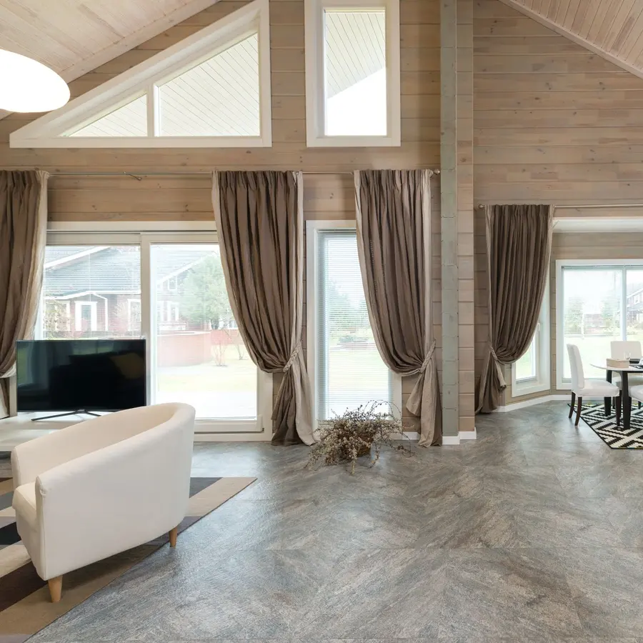 Open-plan living room and kitchen with high ceilings and large windows