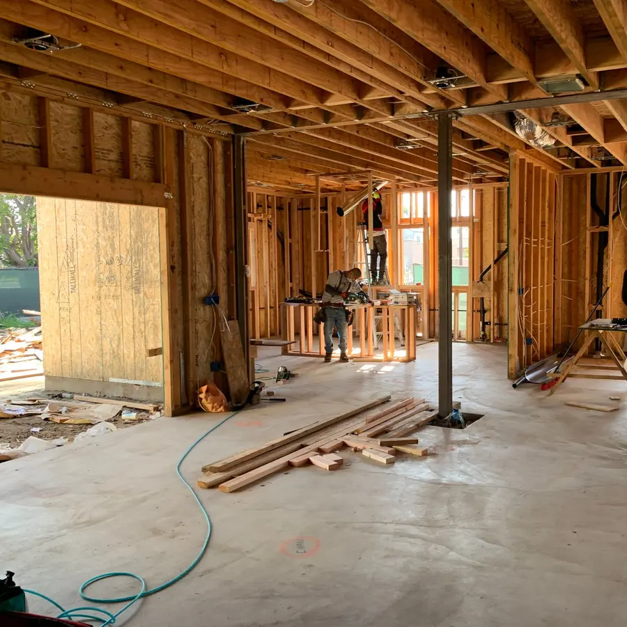 Crew framing the interior of a house under construction