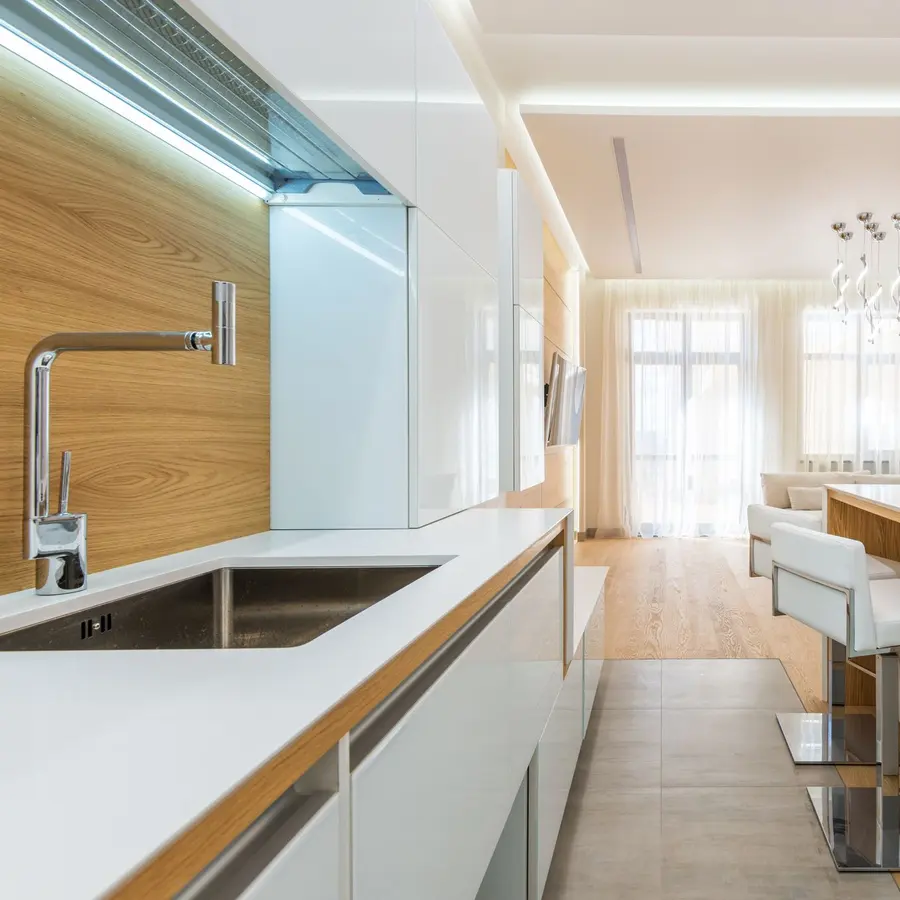 Modern white kitchen with wood countertops and under-cabinet lighting